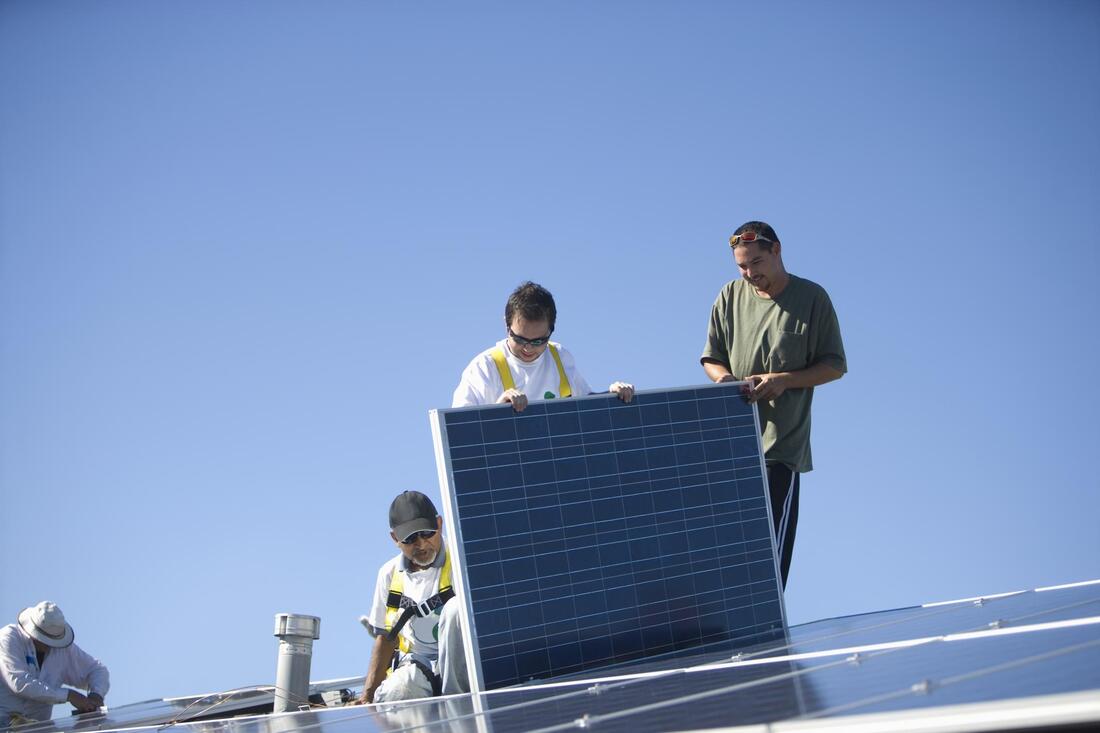 worker holding the solar panel